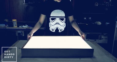 Woman standing in front of the custom-made LED light box.