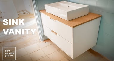 A white wood sink vanity suspended on the wall.