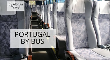 Rows of comfortable looking seats in an empty bus & a custom signs that says 'Portugal by bus'