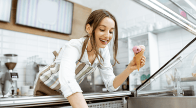 a woman is holding a doughnut in her hand