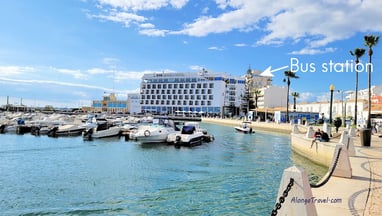 boats floating in Faro marina & an arrow pointing to a building marked 'bus station'