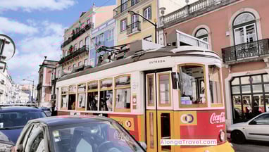 Red tram 28 on the streets of Lisbon, the cheapest place in Europe to fly into