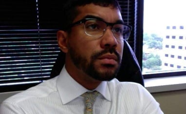 a man in a white shirt and tie dye on a tie