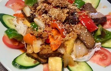a plate of food with vegetables and tempeh