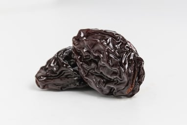 Giant closeup of 2 black raisins