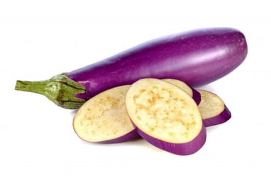 A long purple eggplant with 4 slices piled in front of it