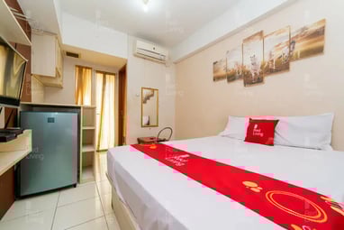 a bed room with a bed and a television