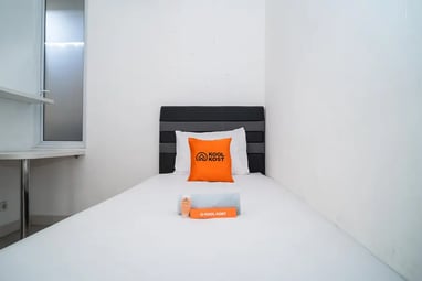 flazale reddoorz flash sale a bed with a pillow and a pillow on top of it