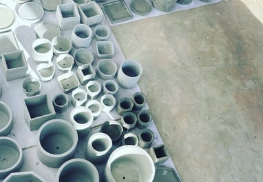 a bunch of different types of clay pots