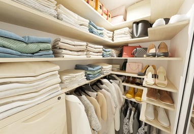 a closet with a lot of clothes and shoes