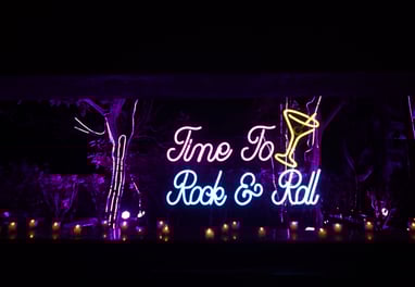 a neon sign that says time to rock and roll