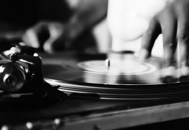 a person is playing a record on a record player