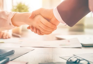 a business meeting with a handshake of two people