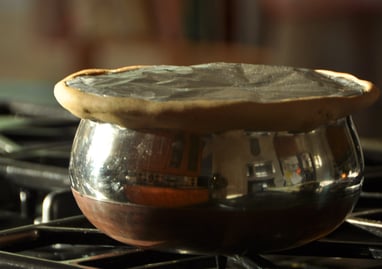 a potted potted with a saucer on top of a stove