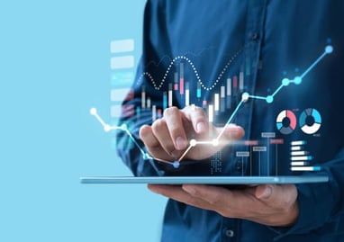 Man holding tablet money, stocks, graph