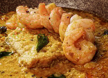 a bowl of food with shrimp and vegetables