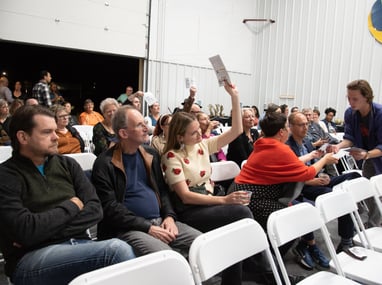 Attendees of the event bidding on pieces.