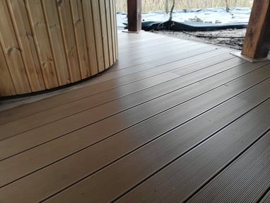 a wooden deck with a hot tub and a wooden deck