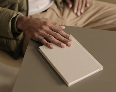 a person sitting at a table with a book