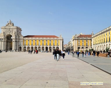 Wide square of commerce built during Pombaline reforms in Lisbon, with people enjoying their walk