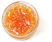 Top down view of a little, clear, open container of papaya preserves