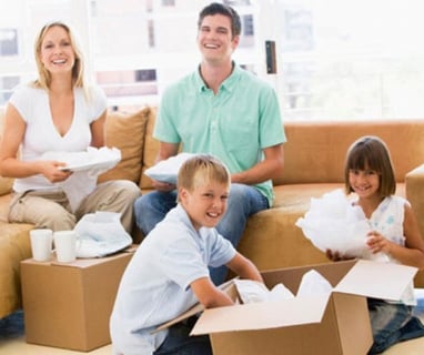 a family moving boxes in a living room