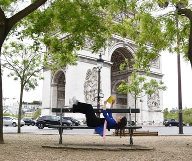 Slow life in a fussy city like Paris. A woman reading her book in front of Arc de Triomphe