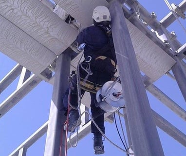 a man in a helmet and a helmet on a pole