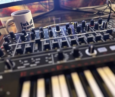 MiniBrute 2 On Desk with Fuck Off I'm Mixing Mug
