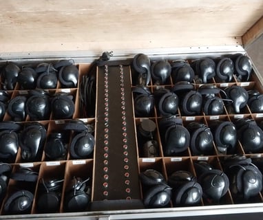 a suitcase with many different types of headphones