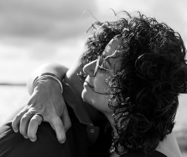 Plan rapproché d'un couple s'enlaçant sur la plage lors d'une séance photo au bassin d'arcachon