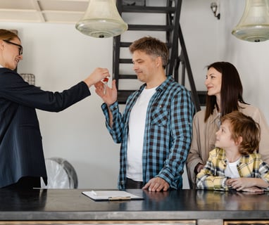 a man and woman shaking hands in a kitchen