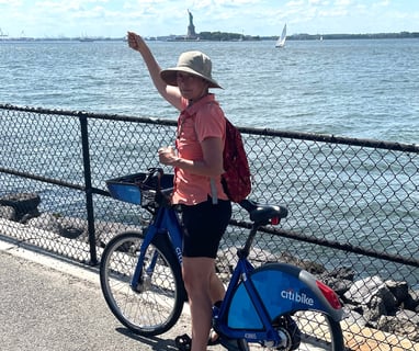 Andreae on bike before the Statue of Liberty