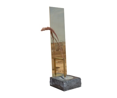 Multiverse sculpted vase in green granite and polished brass. Water, reflection
