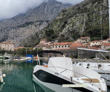 A few boats in Kotor bay in front of majestic looking ⛰ & Kotor sitting at the bottom of the ⛰