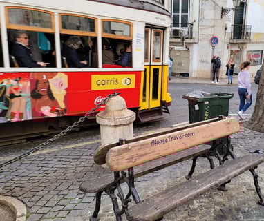 A crowded tram 28 car passes in popular Alfama distric of Lisbon