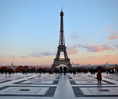 Eiffel Tower hovers over skyline of Paris, a place to fly cheaply into in Europe