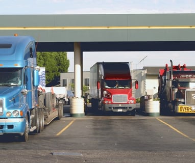 a truck with a semi truck parked in a parking lot