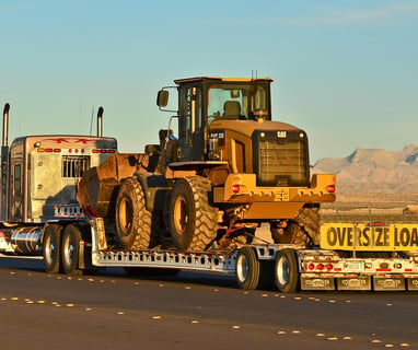 a tractor trailer with oversize load banner