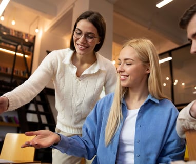 a woman and man are looking at a laptop