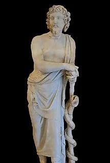 Statue of Asclepius leaning on a rod entwined with a serpent