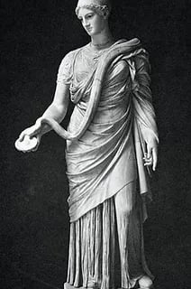 A statue of Hygeia feeding a snake out of a bowl