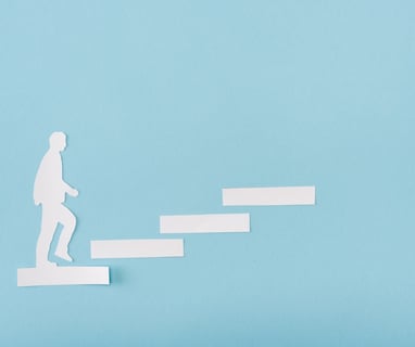 a person walking up stairs with a paper cutout of a man