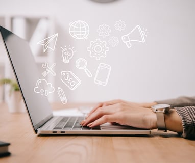 a person sitting at a desk with a laptop