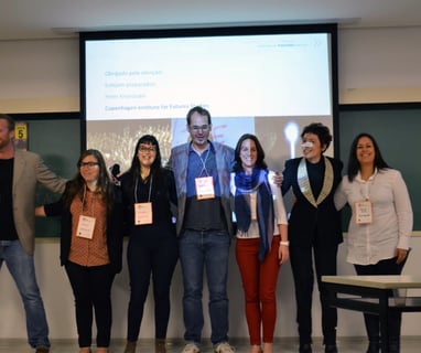 a group of people standing around a presentation