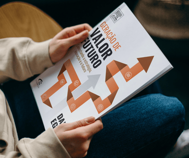 a person sitting on a chair with a book about how to write a book