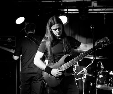 a man tuning guitar on stage