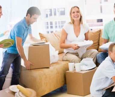 a family moving boxes in a living room