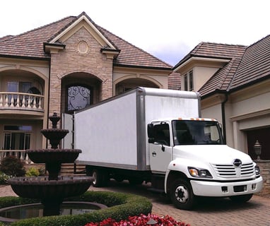 a moving truck parked in front of a house