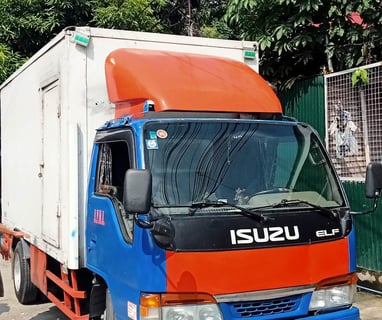 a truck with a trailer parked in front of a house